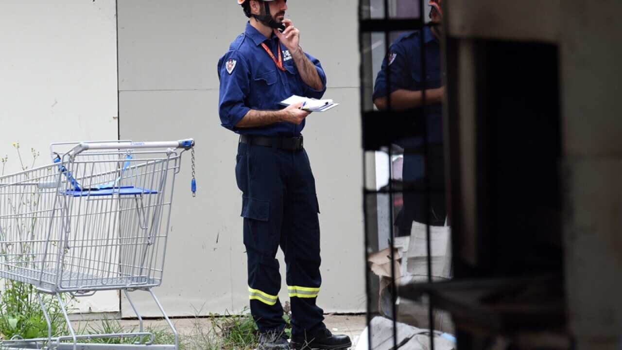 Fire and Rescue officers survey properties burnt by fire in Sydney