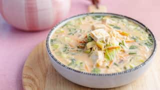 Creamy noodle soup sits in a bowl.