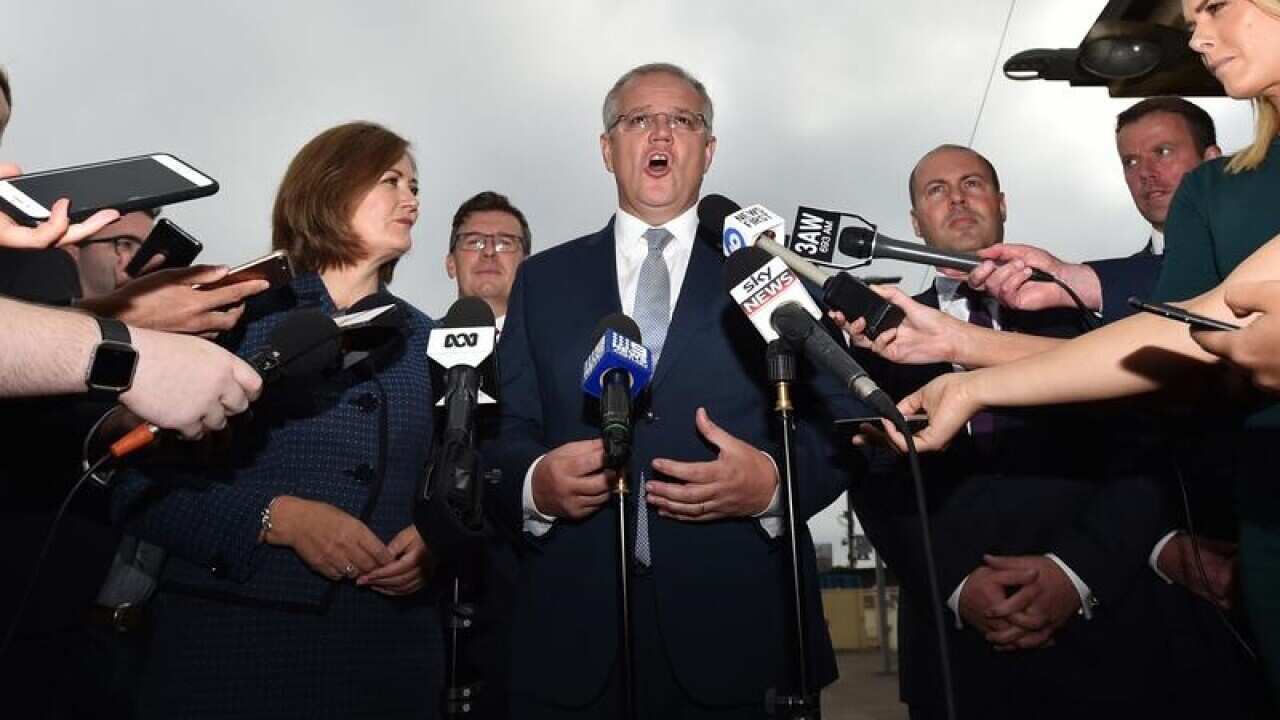 Prime Minister Scott Morrison (centre) addresses the media in Victoria