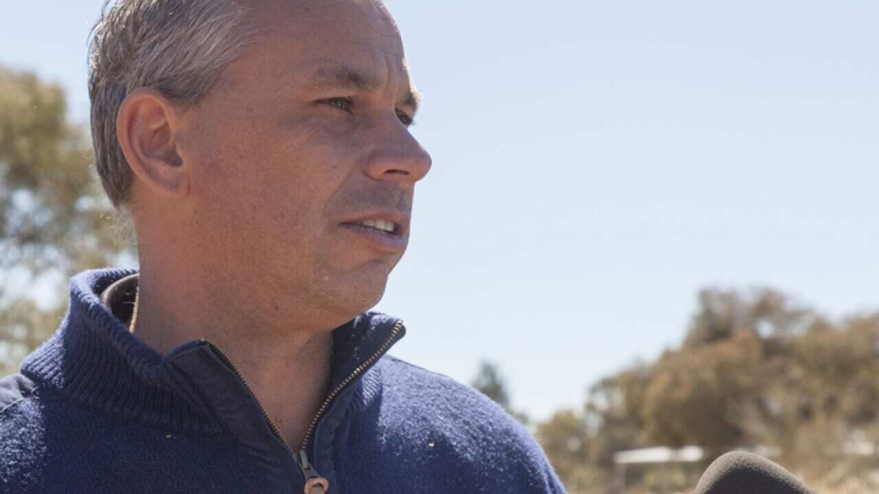 Northern Territory Chief Minister Adam Giles (L) speaks to the media