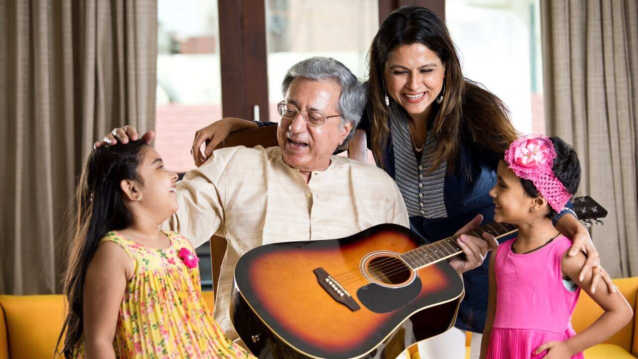 Happy family with guitar at home