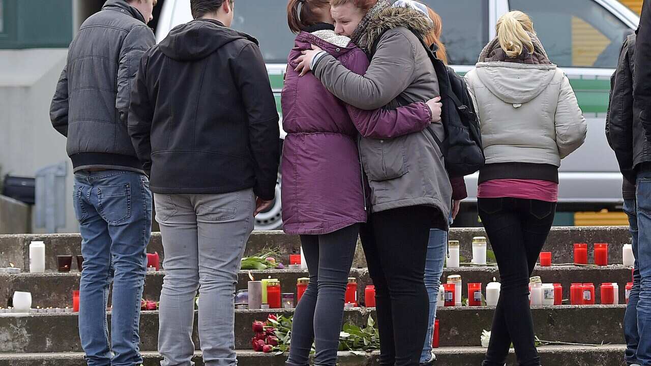 School children mourn for their school mates in front of the Joseph-Koenig Gymnasium in Haltern, western Germany Tuesday, March 24, 2015.(AP Photo/Martin Meissner)