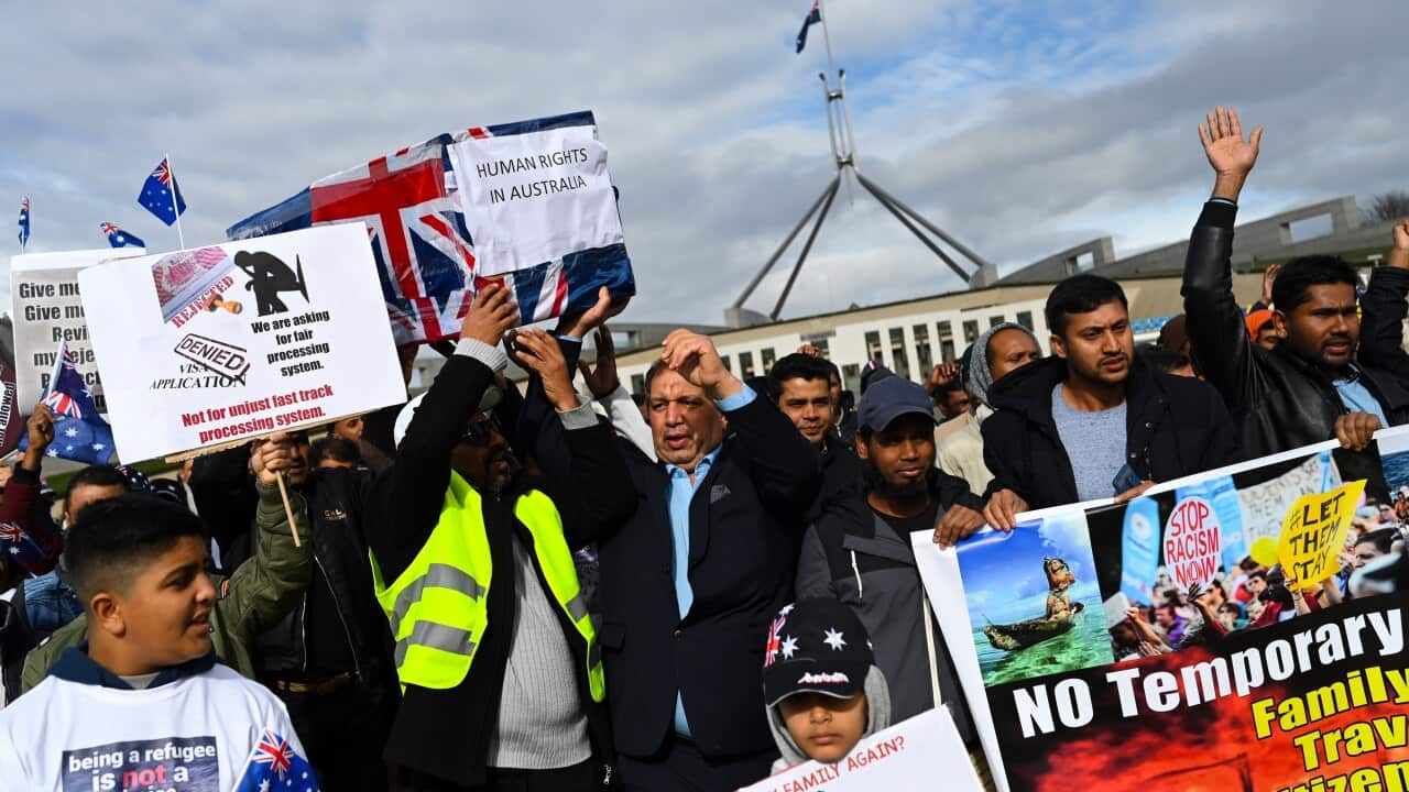 Temporary Protection Visa (TPV) and Safe Haven Enterprise Visa (SHEV) holders are seen as they attend a rally outside Parliament House in Canberra, Monday, 29 July, 2019. (AAP Image/Lukas Coch) NO ARCHIVING