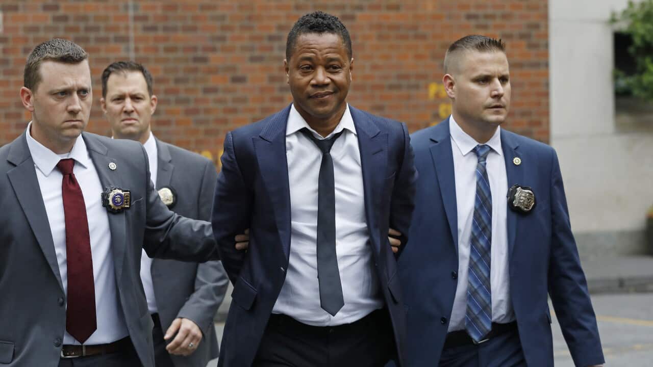 Actor Cuba Gooding Jr is lead by police officers from the New York Police Department's special victims division, 