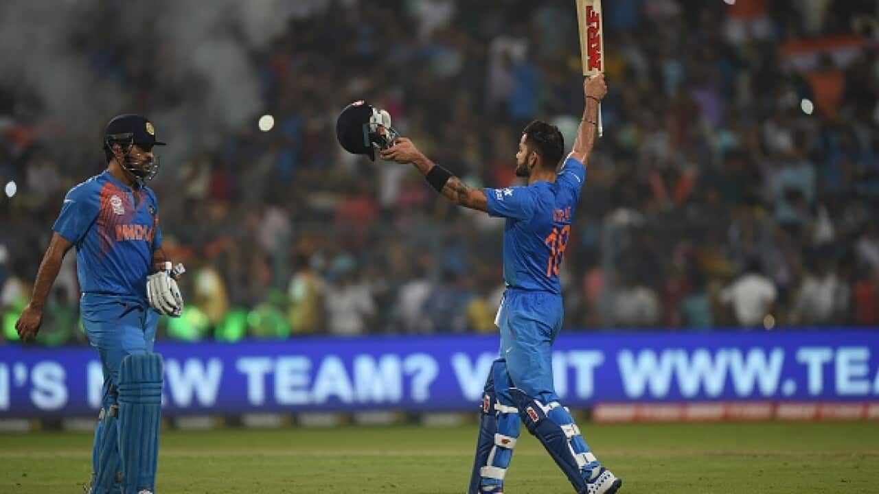 India's Virat Kohli(R)celebrates with captain Mahendra Singh Dhoni after victory in the World T20 cricket tournament match between India and Pakistan at The Eden Gardens Cricket Stadium in Kolkata on March 19, 2016. / AFP / Prakash SINGH