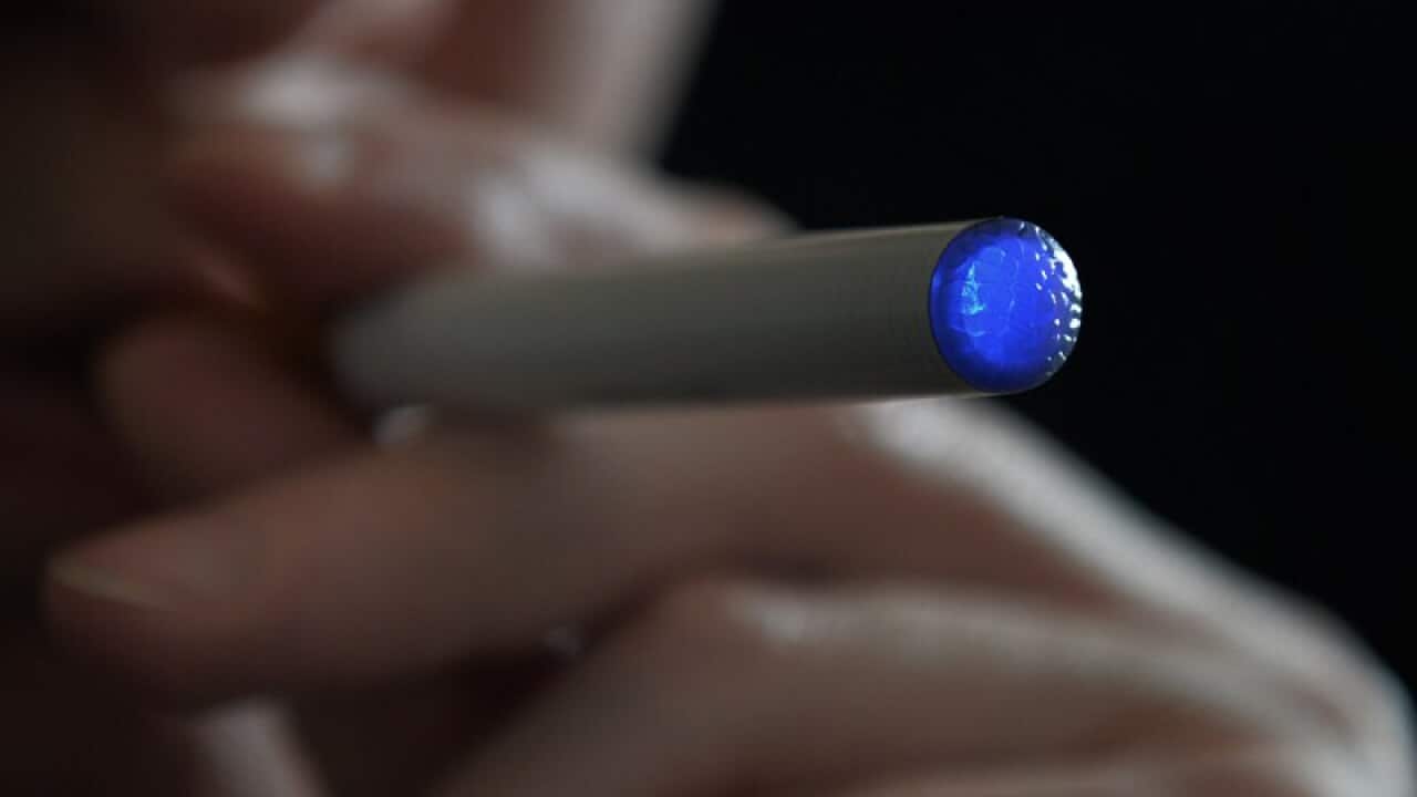 A person smoking an e-cigarette.