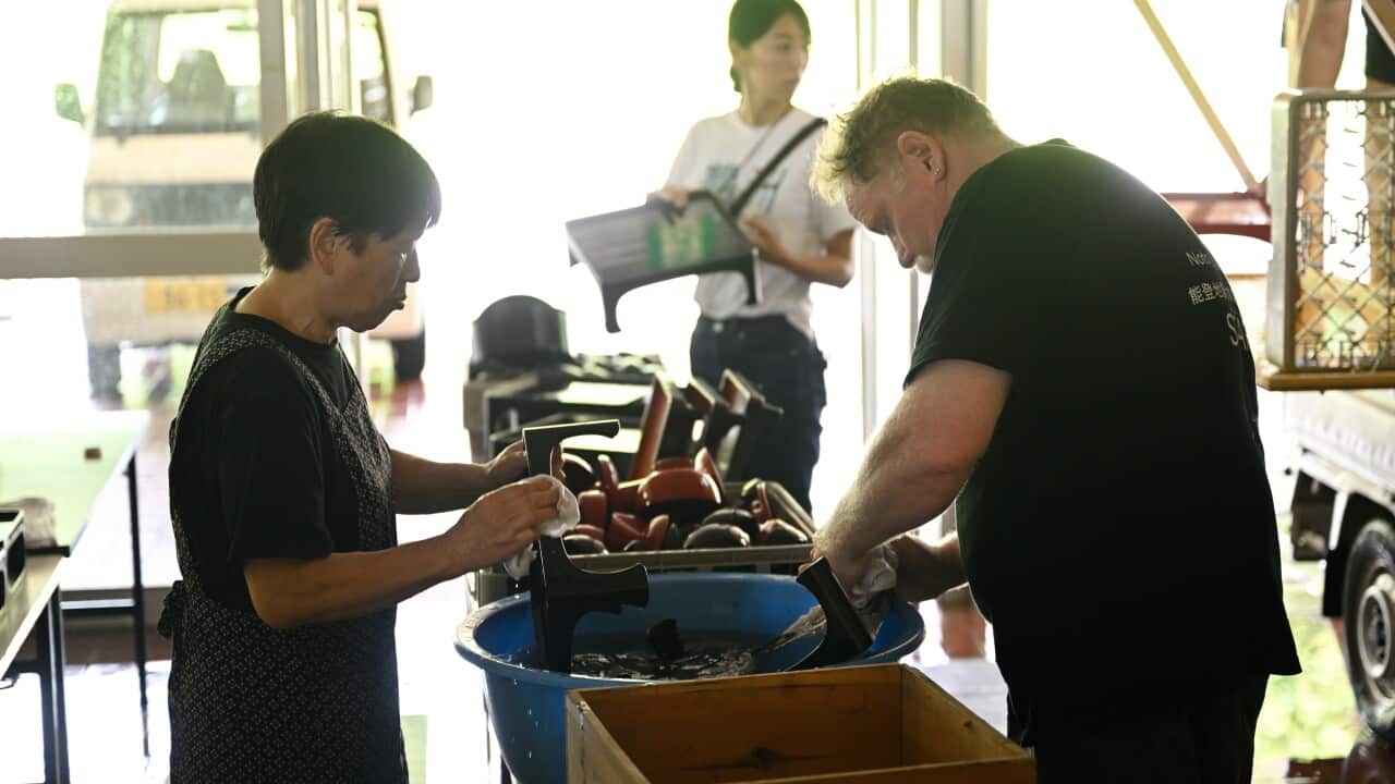 Washing wajima-nuri (Japanese lacquerware from Wajima) that were rescued from the damaged house of the earthquake