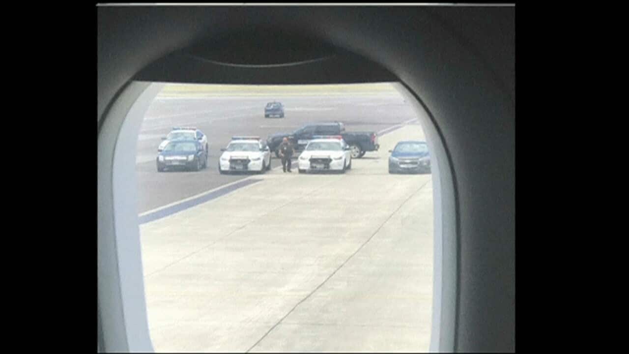 Police cars seen on the tarmac after the plane landed safely.