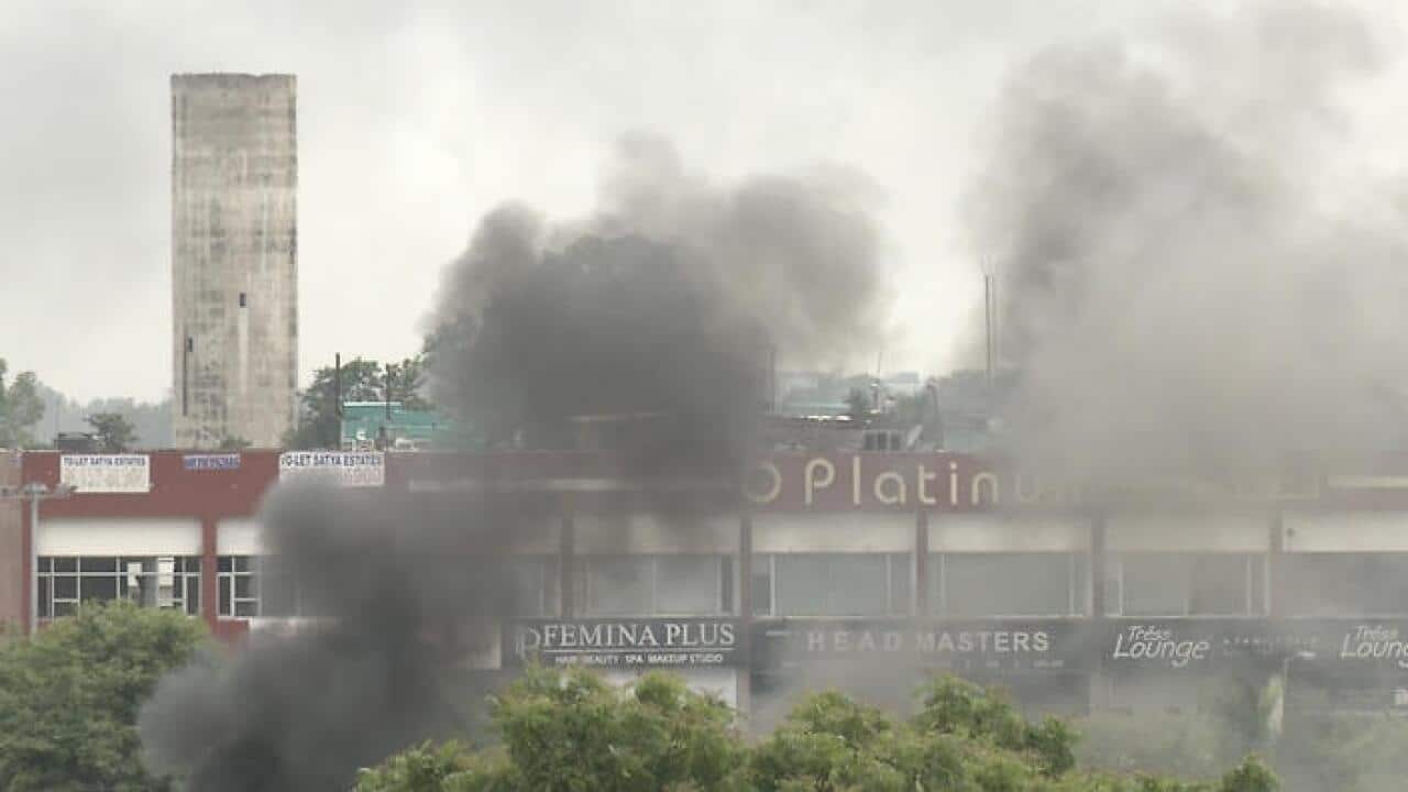 Smoke rises as supporters of an Indian guru who calls himself Saint Dr. Gurmeet Ram Rahim Singh Ji Insaan react after his verdict was announced in India  