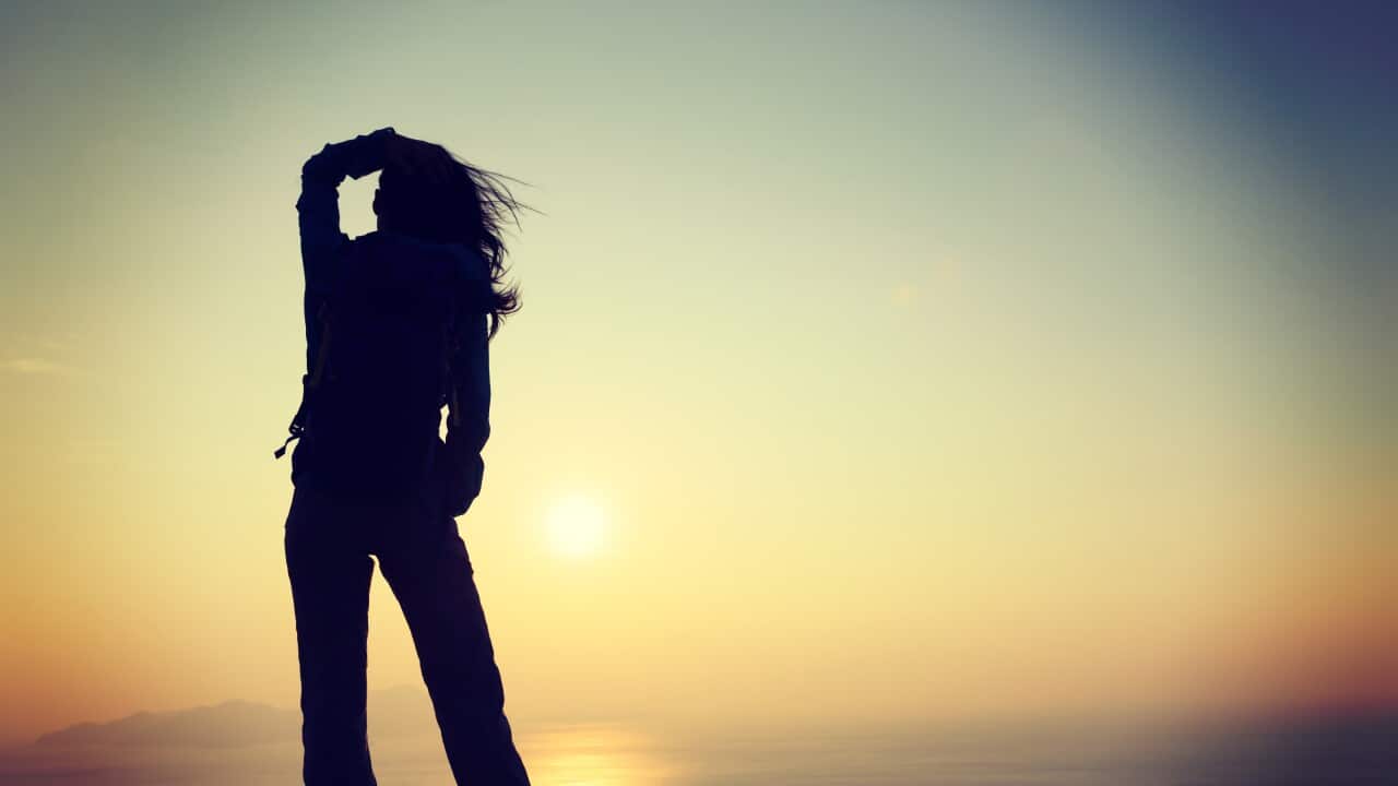 Freedom Woman with Backpack Standing on Sunrise Bali