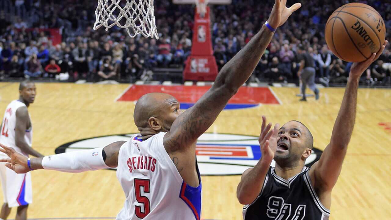 San Antonio Spurs guard Tony Parker, right, of France, shoots