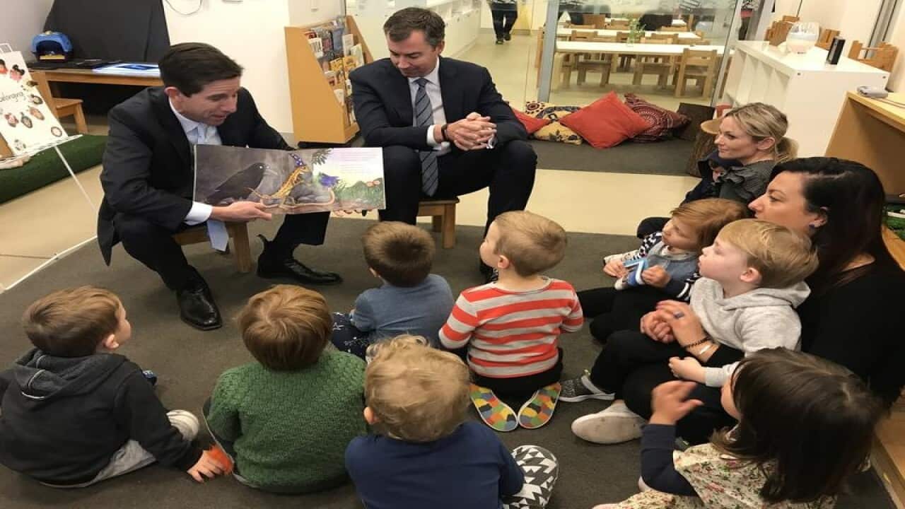 Minister for Education and Training Simon Birmingham (L)