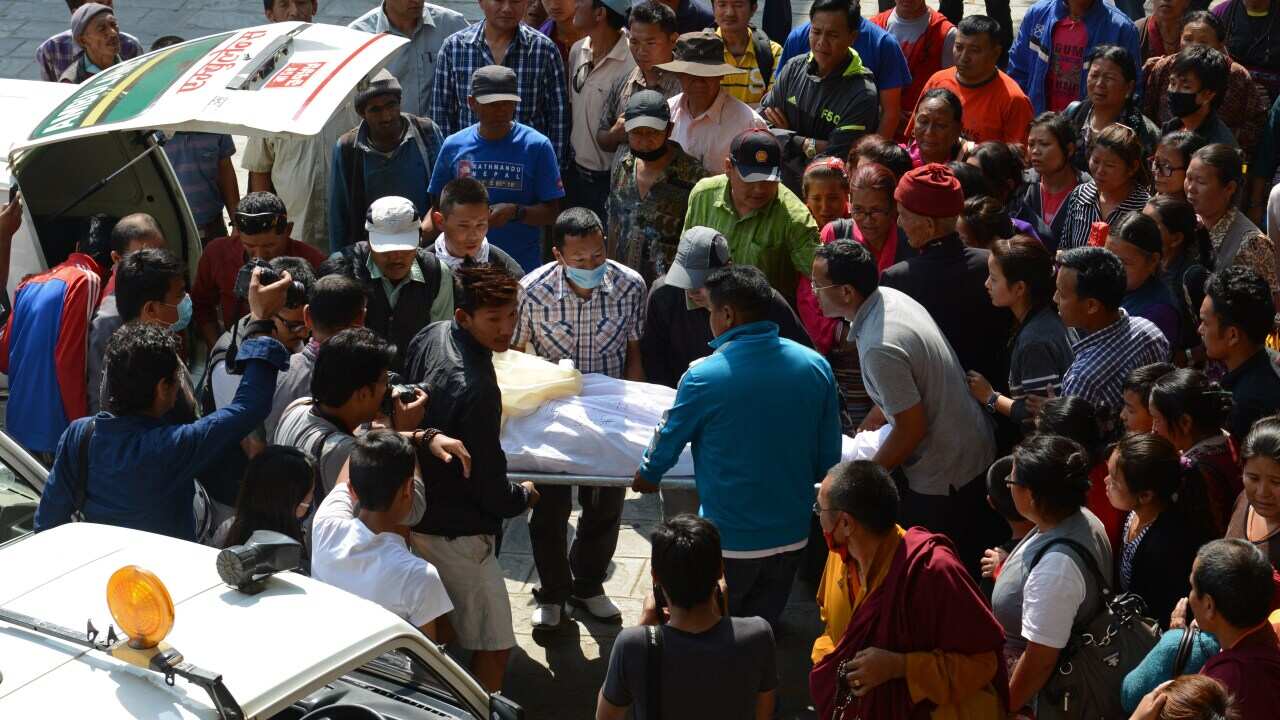 Nepalese relatives and volunteers shift the body of a Mount Everest avalanche victim after arrival at the Sherpa Monastery in Kathmandu on April 19, 2014 (Getty)