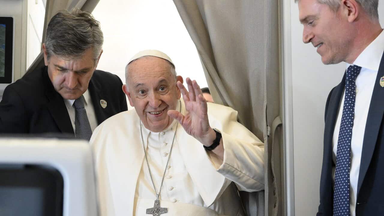 Pope Francis onboard a plane