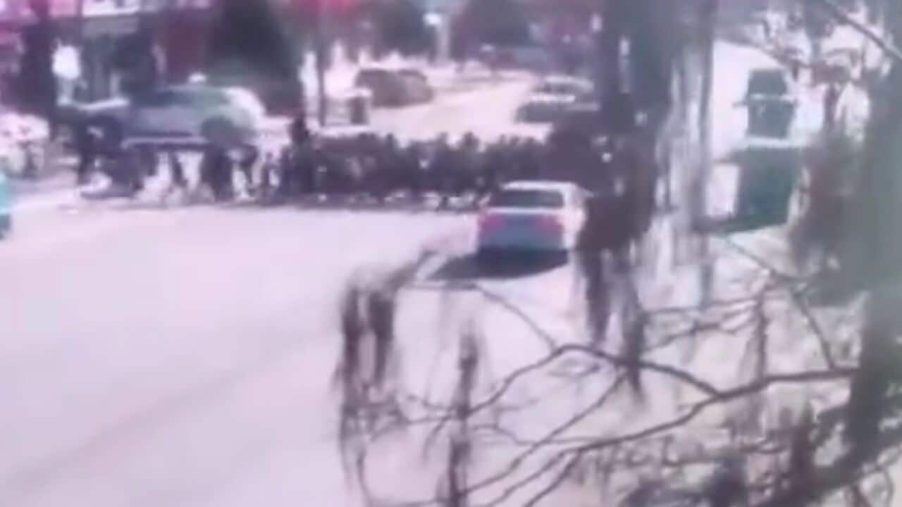 Security camera footage showed the moment a car drove into the group outside a school.