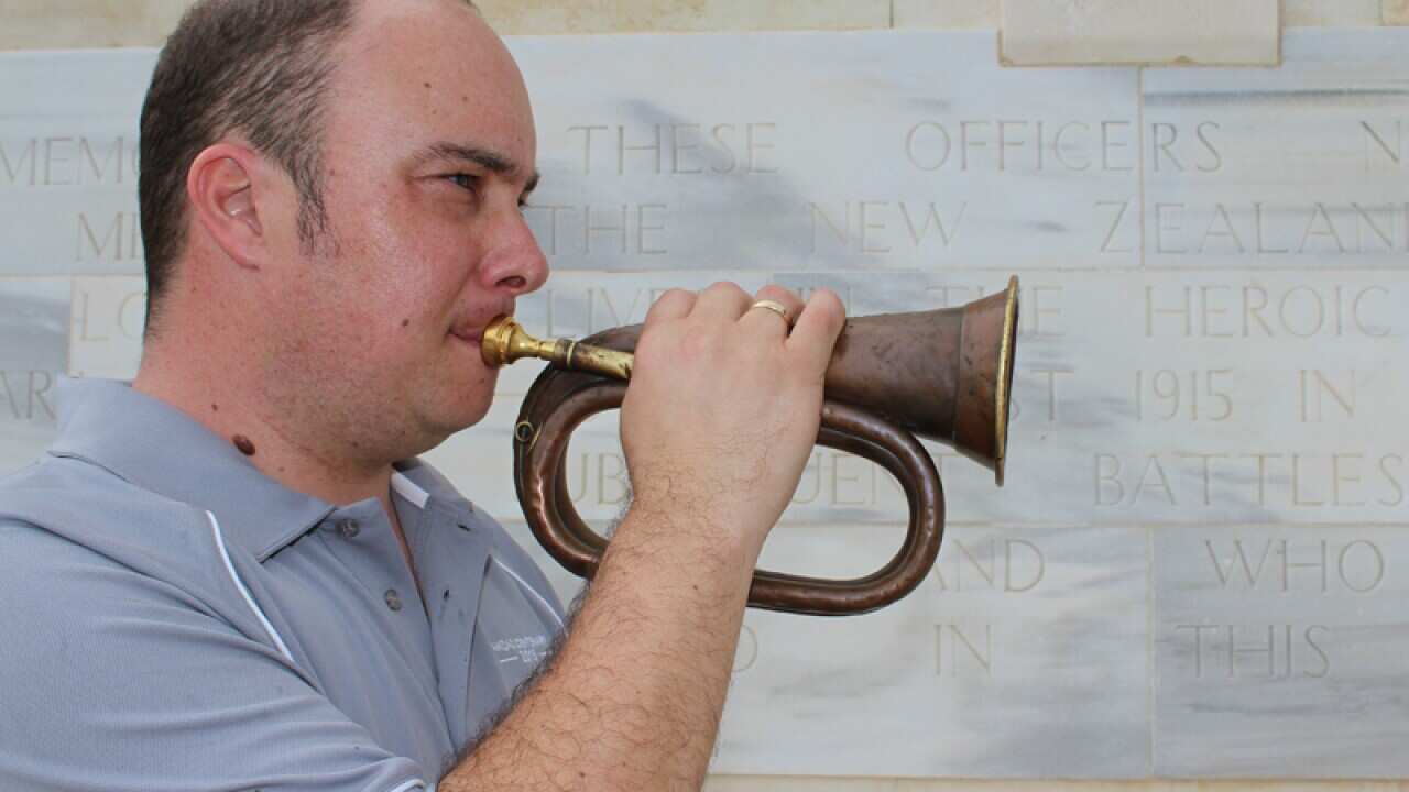 New Zealand Navy leading musician Colin Clark plays a bugle