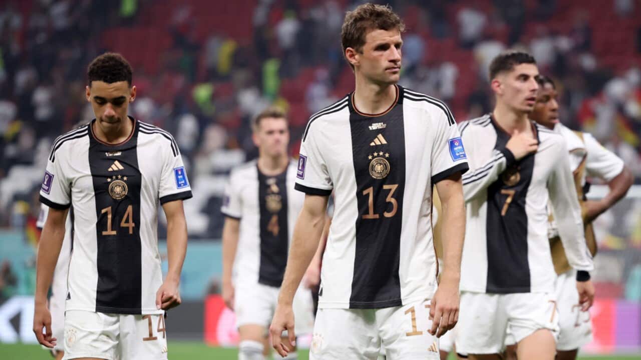 Jamal Musiala, Thomas Muller and Kai Havertz look on after a Germany defeat