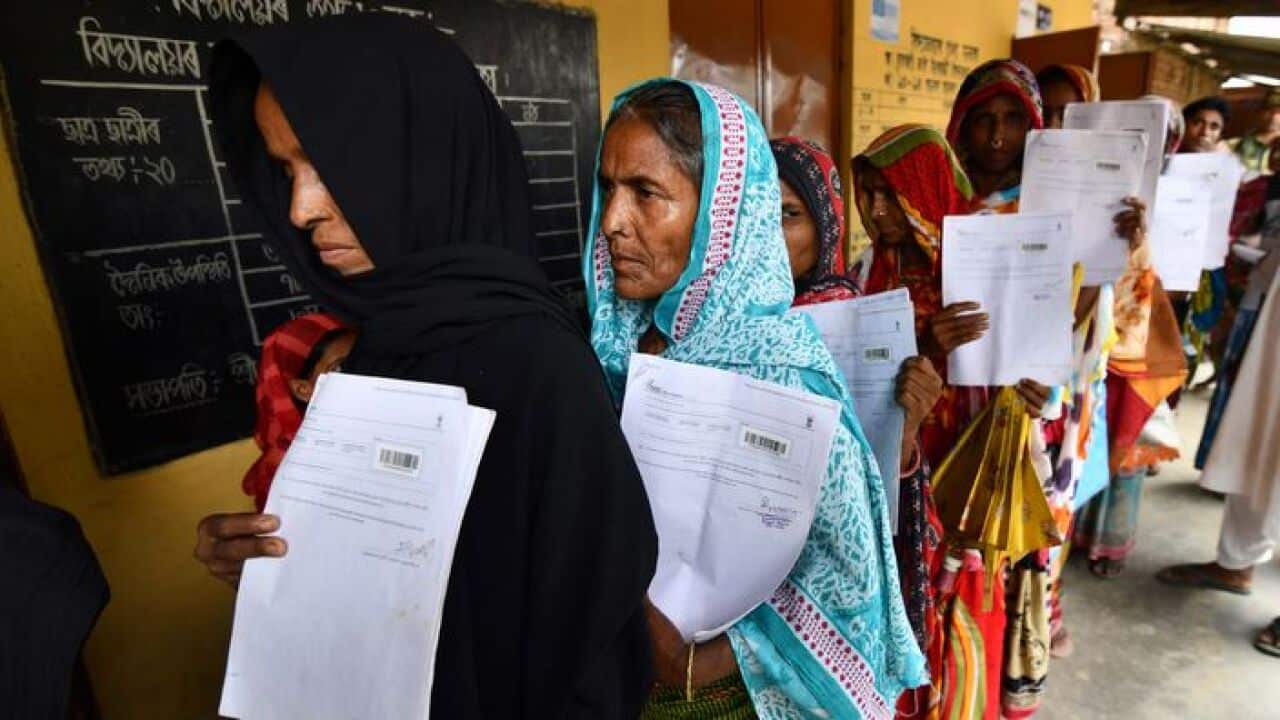 Residents queue to check their names on the final National Register of Citizens
