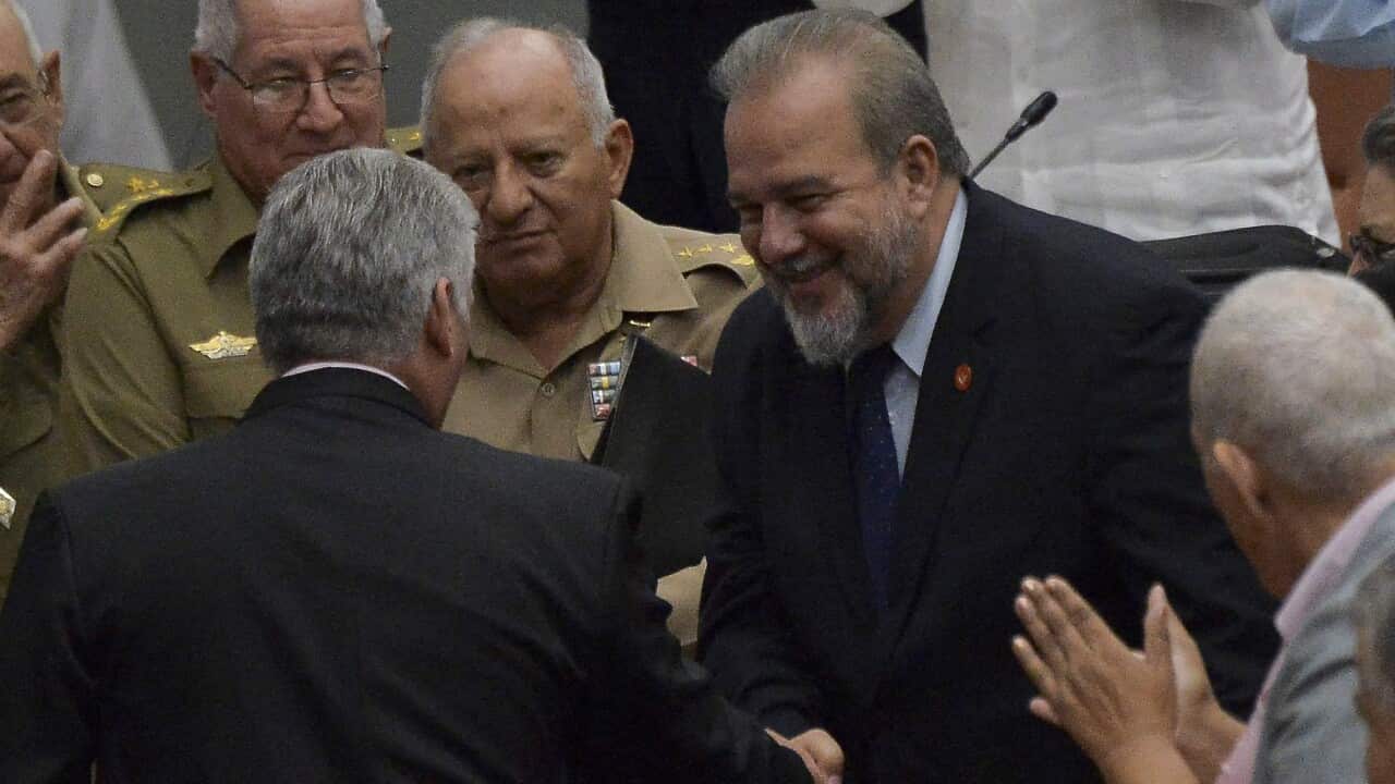Cuban Prime Minister Manuel Marrero Cruz (R) greets Cuban President Miguel Diaz Canel (L-back to camera).