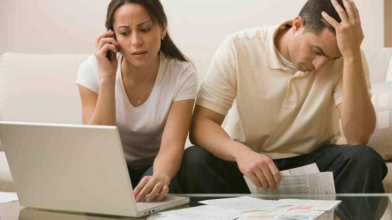 Stressed couple paying bills