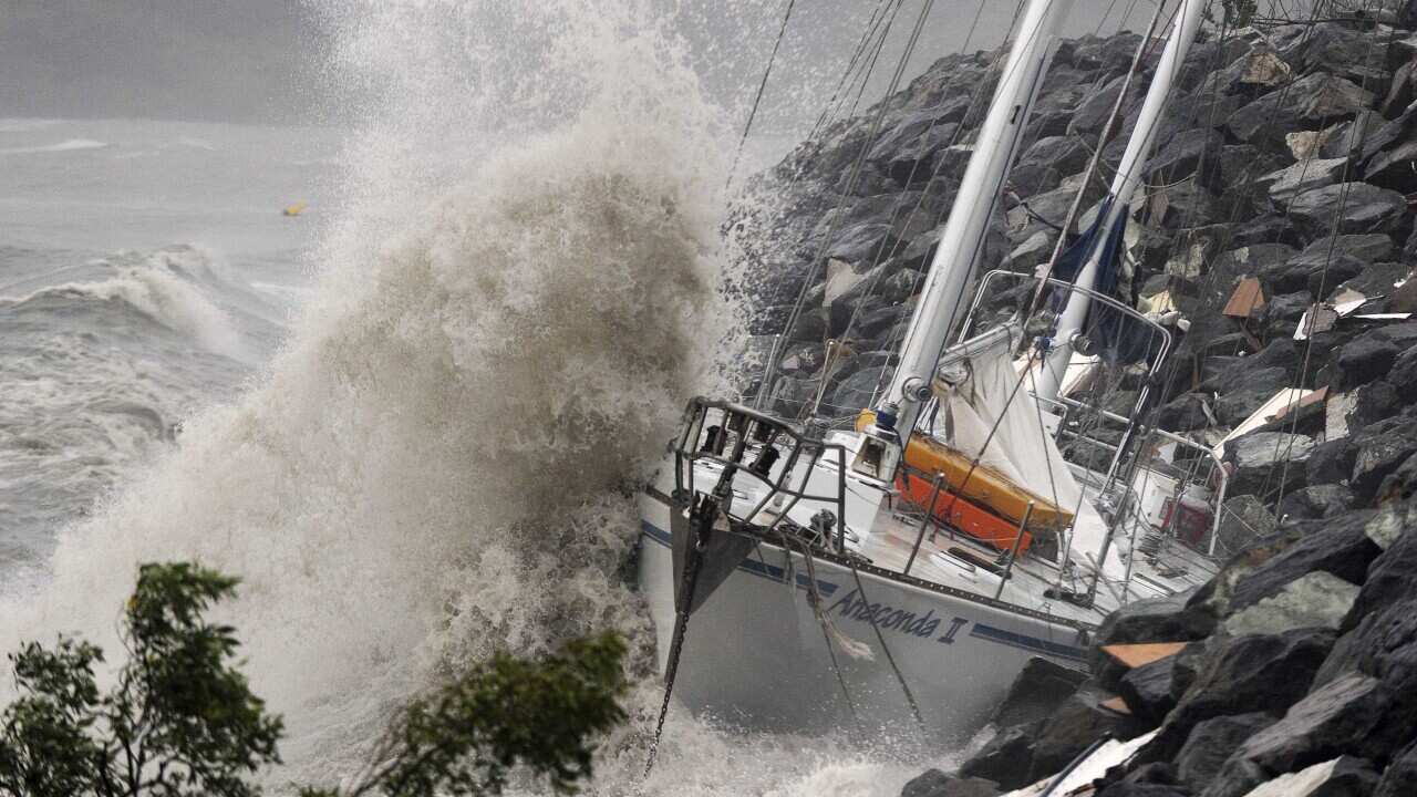 Waves stirred up by Tropical Cyclone Ului batter race yacht Anaconda at Airlie Beach, Australia Sunday, March 21, 2010.