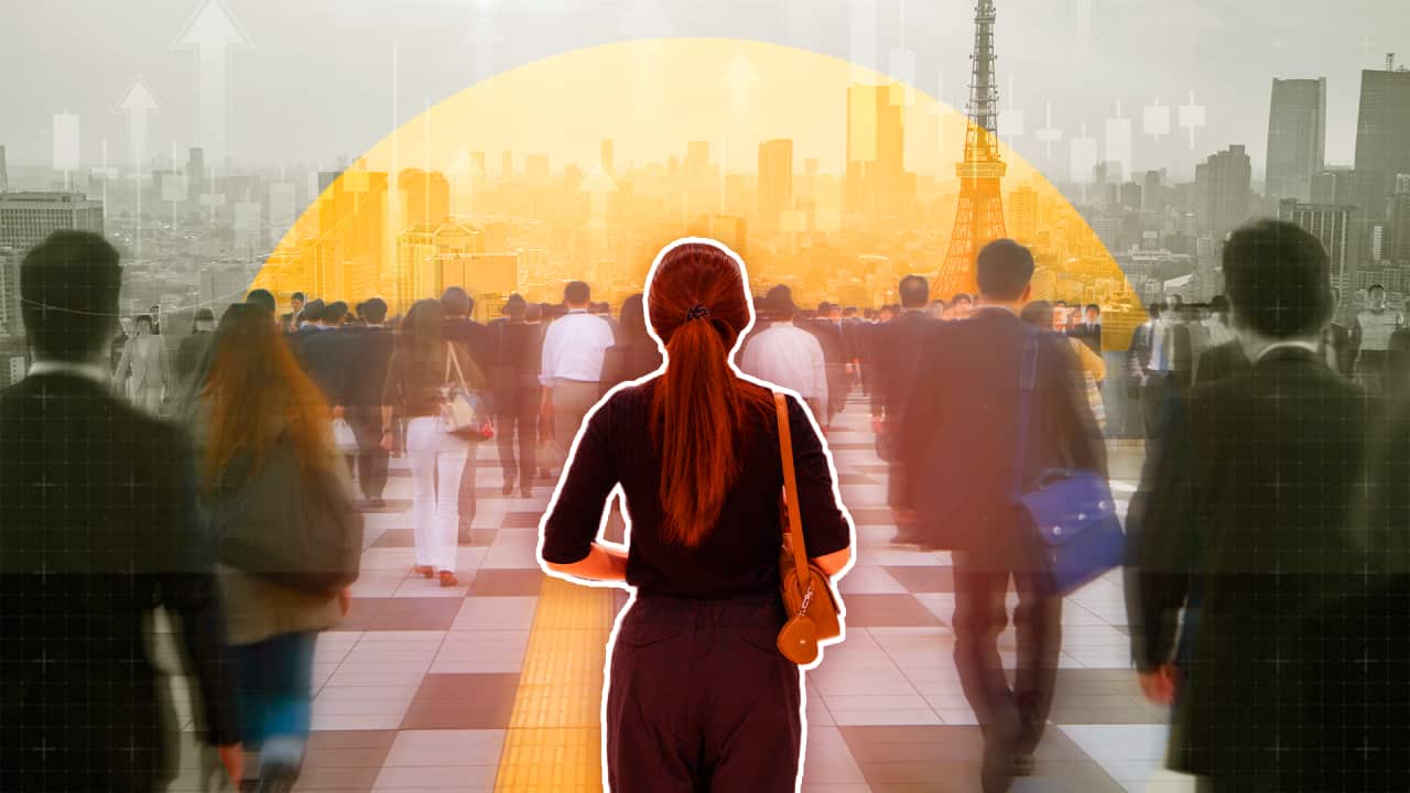 A designed composite image showing a woman from behind as she stands in a crowd of other office workers with Tokyo's skyline as the backdrop.
