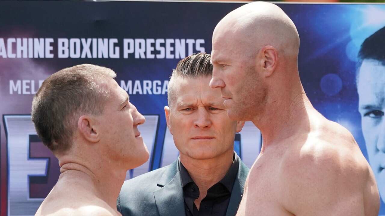 Paul Gallen (left) and Barry Hall face off as promoter Danny Green looks on during an official weigh-in