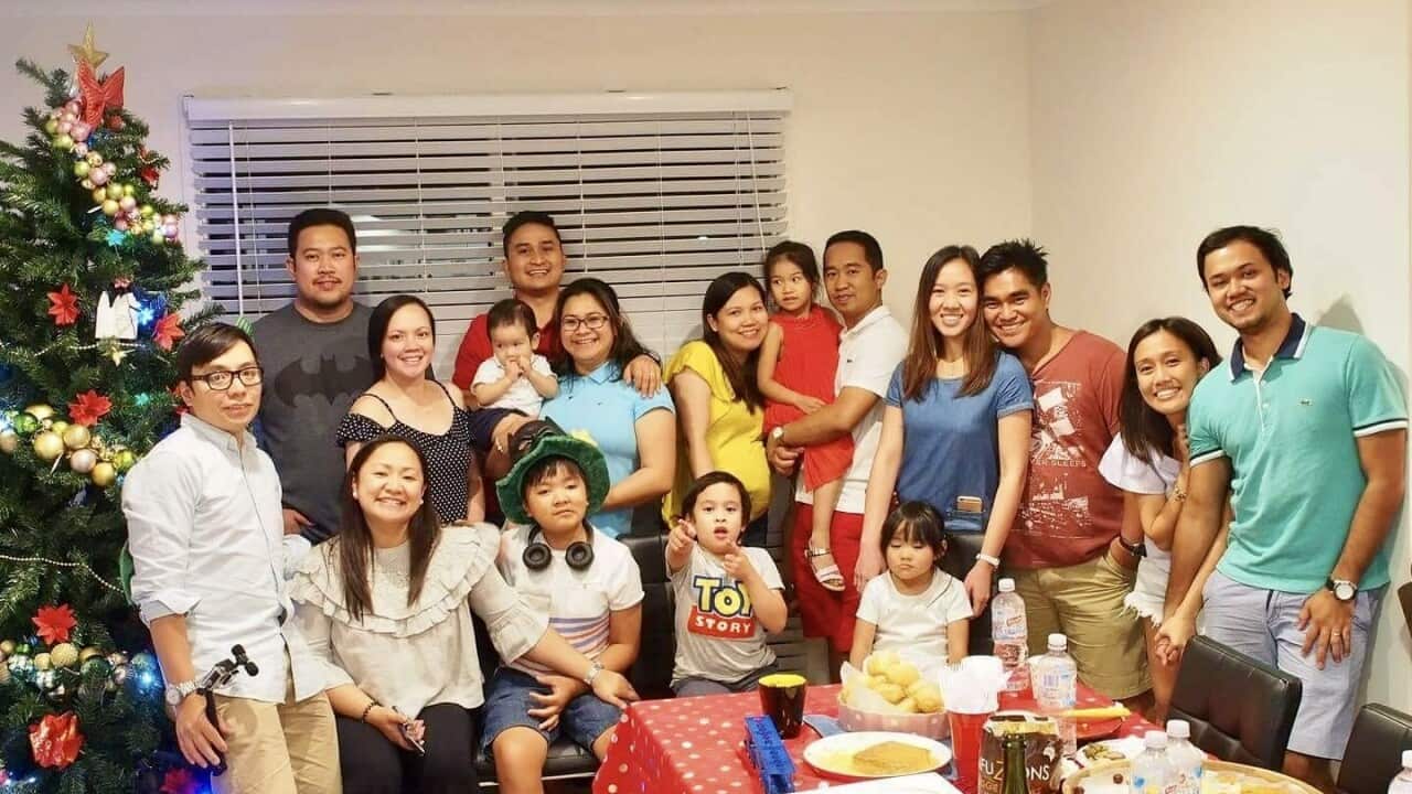 Joan Angelina Mercader with the families she took in her home