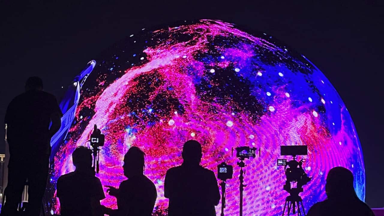 People watching and filming the MSG Sphere
