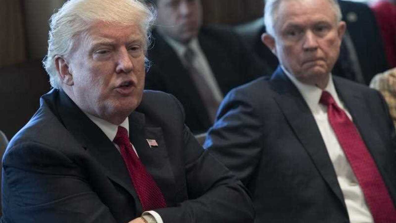 US President Donald J. Trump (L), with Attorney General Jeff Sessions (R),