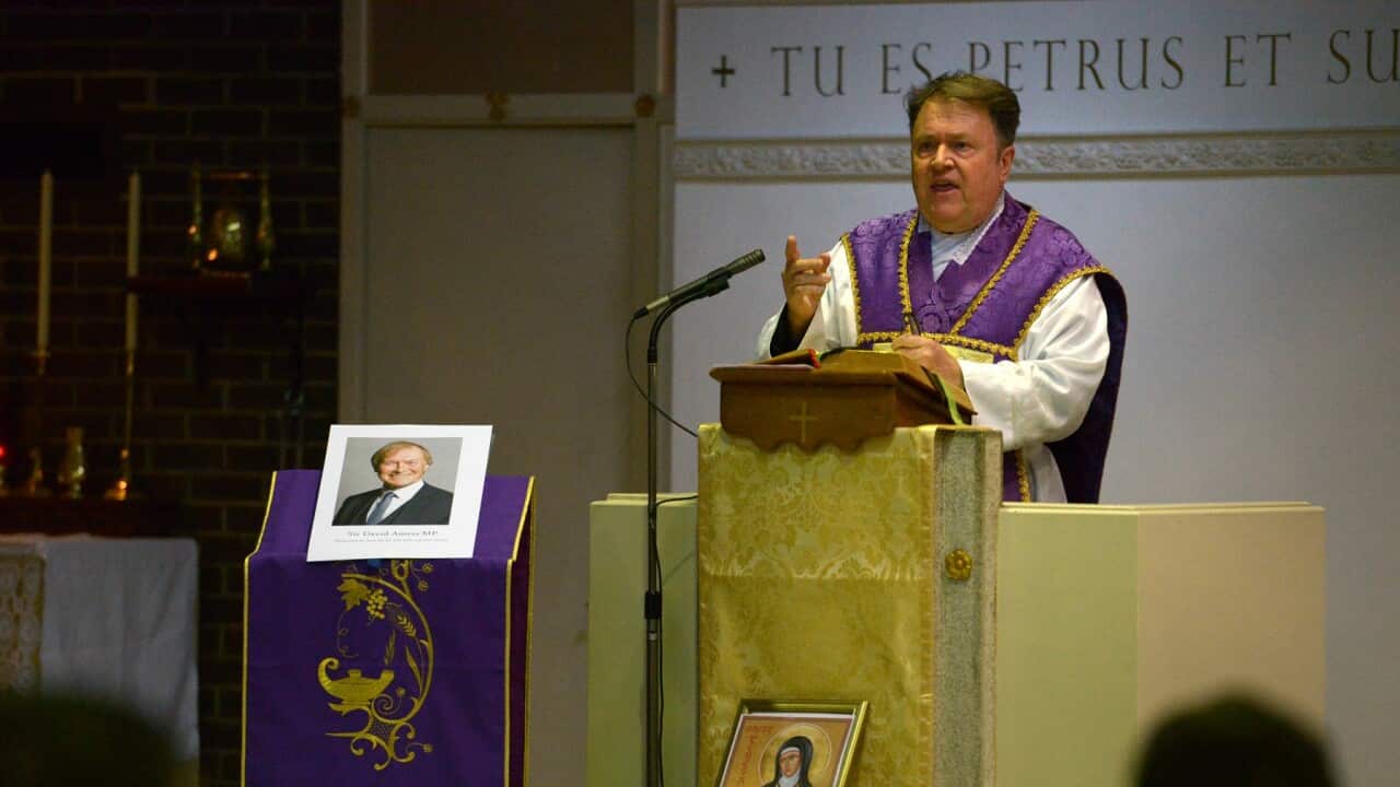 Priest conducting a service after the murder of Sir David Amess