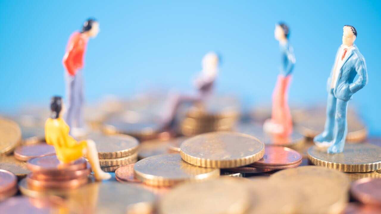 Abundance of money. Symbolic image showing people (figurines) on mountains of money.. Big bank concept.
