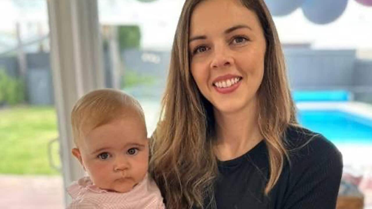 A woman holding a baby.