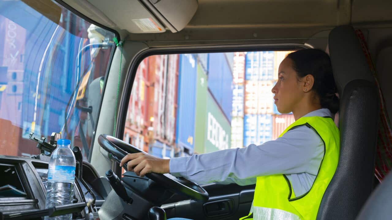 Latin woman is working as trucking driver.