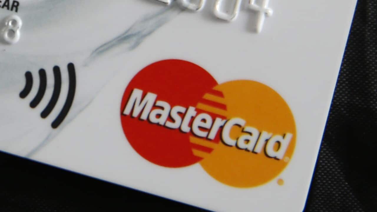 A close-up photo of a Mastercard credit card with the company's logo of overlapping red and yellow circles.