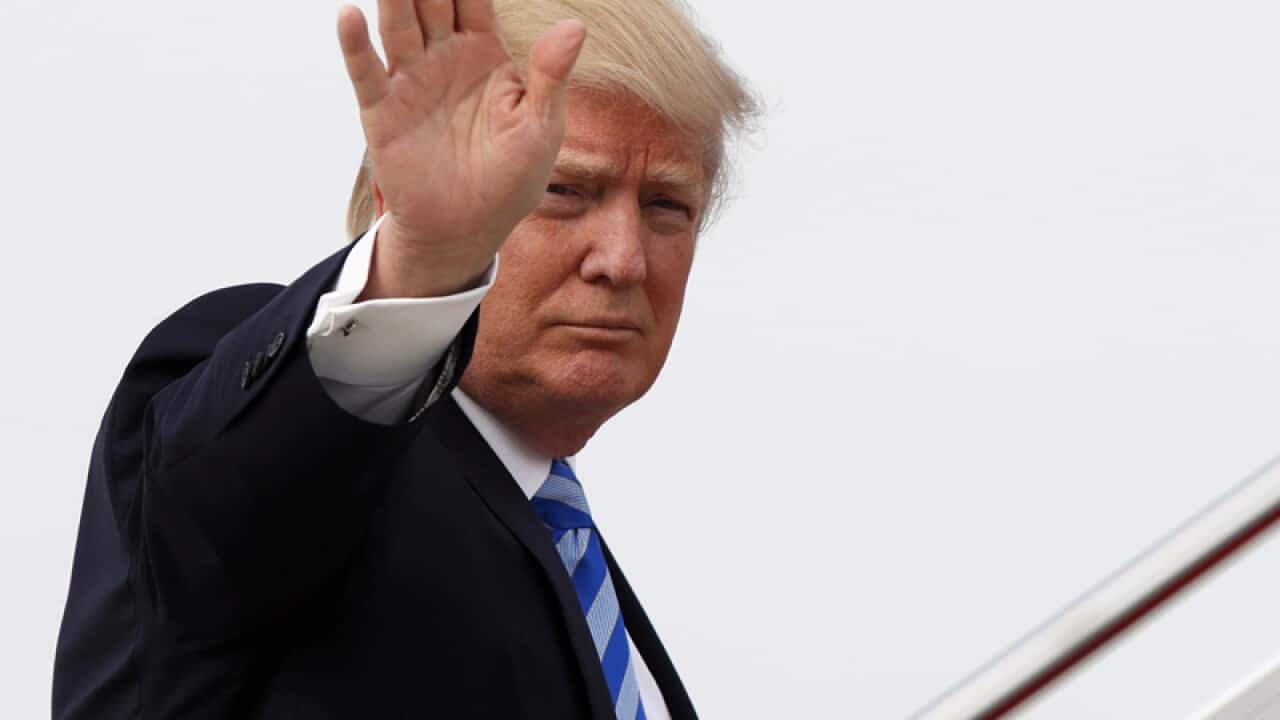 Donald Trump waves as he boards Air Force One