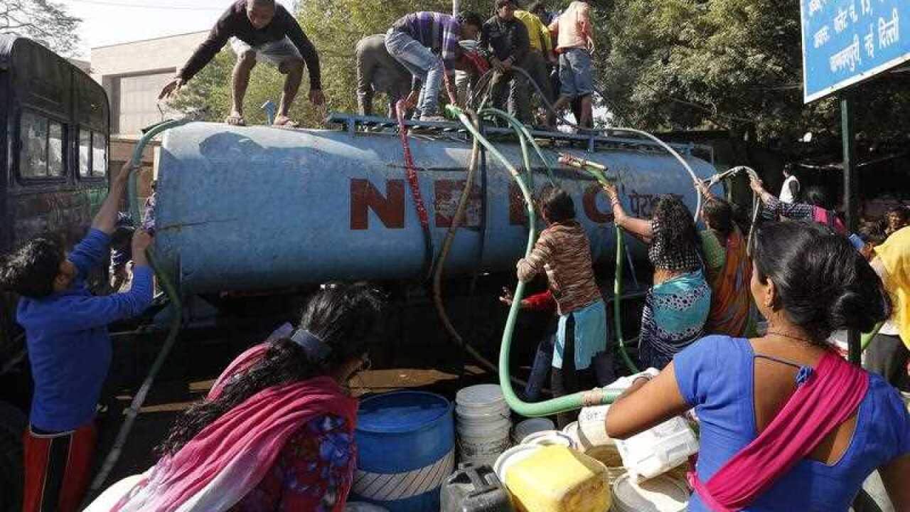 Indian people fill up canisters and containers with water from a tanker in New Delhi, India, 22 February 2016.