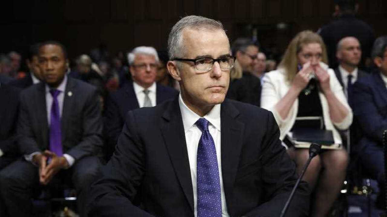 Acting FBI Director Andrew McCabe sits with a folder marked "Secret" in front of him while testifying on Capitol Hill in Washington