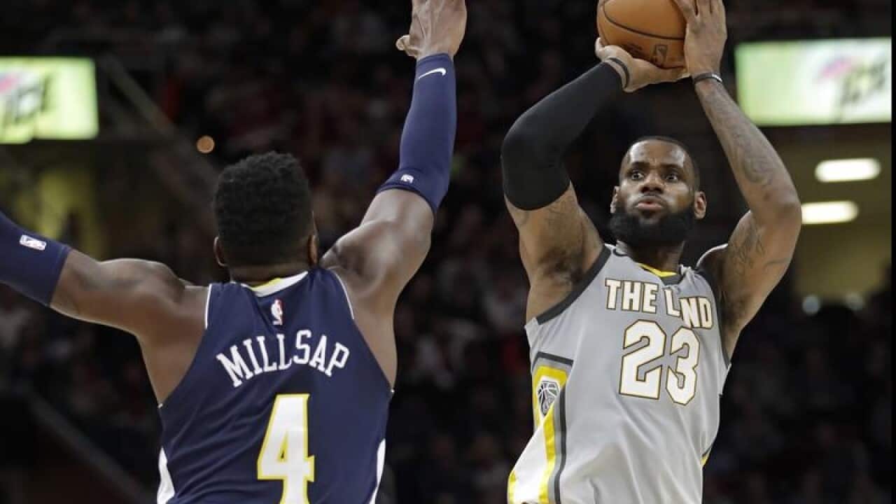 Cleveland's LeBron James shoots over Denver's Paul Millsap