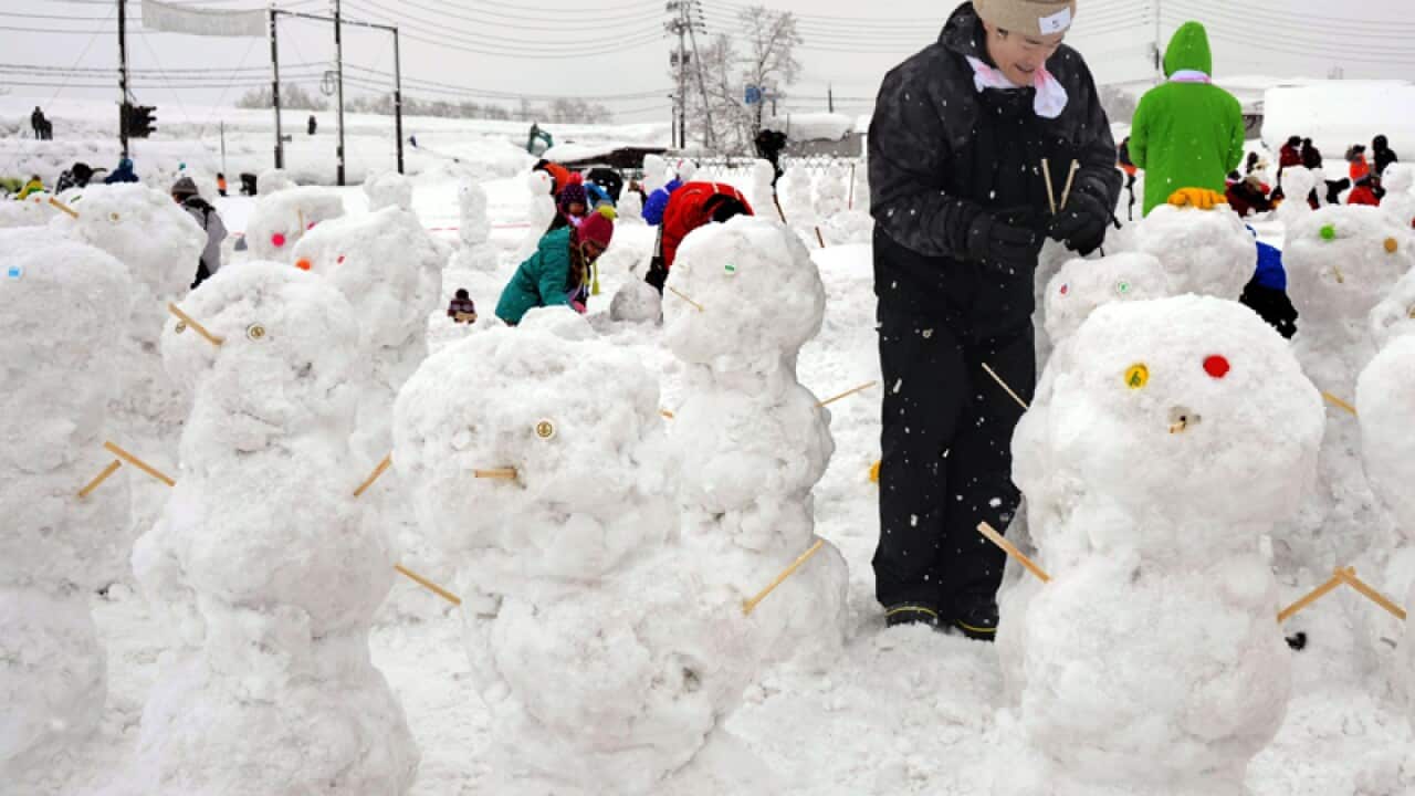 Participants in an event create snowmen