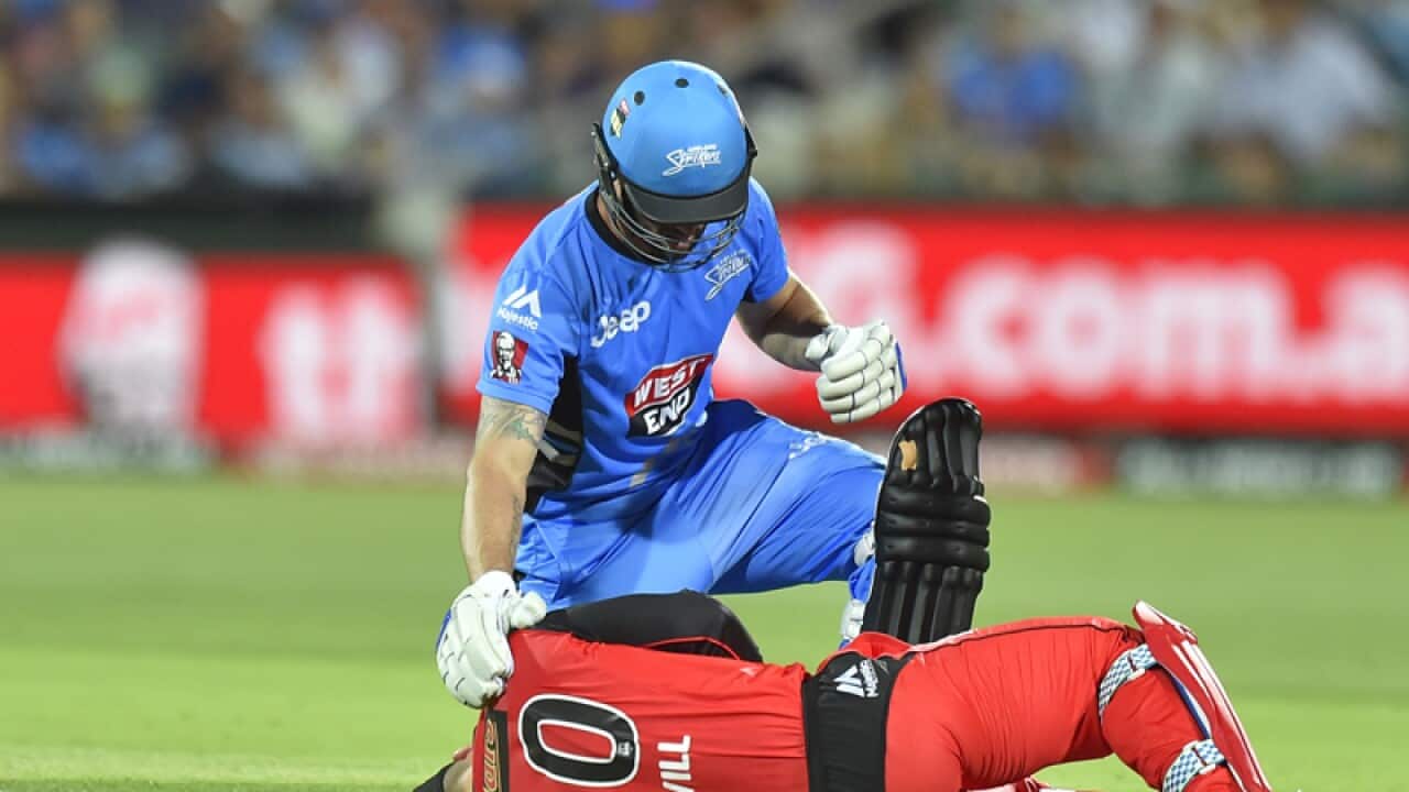 Jono Dean of the Adelaide Strikers checks on Peter Nevill