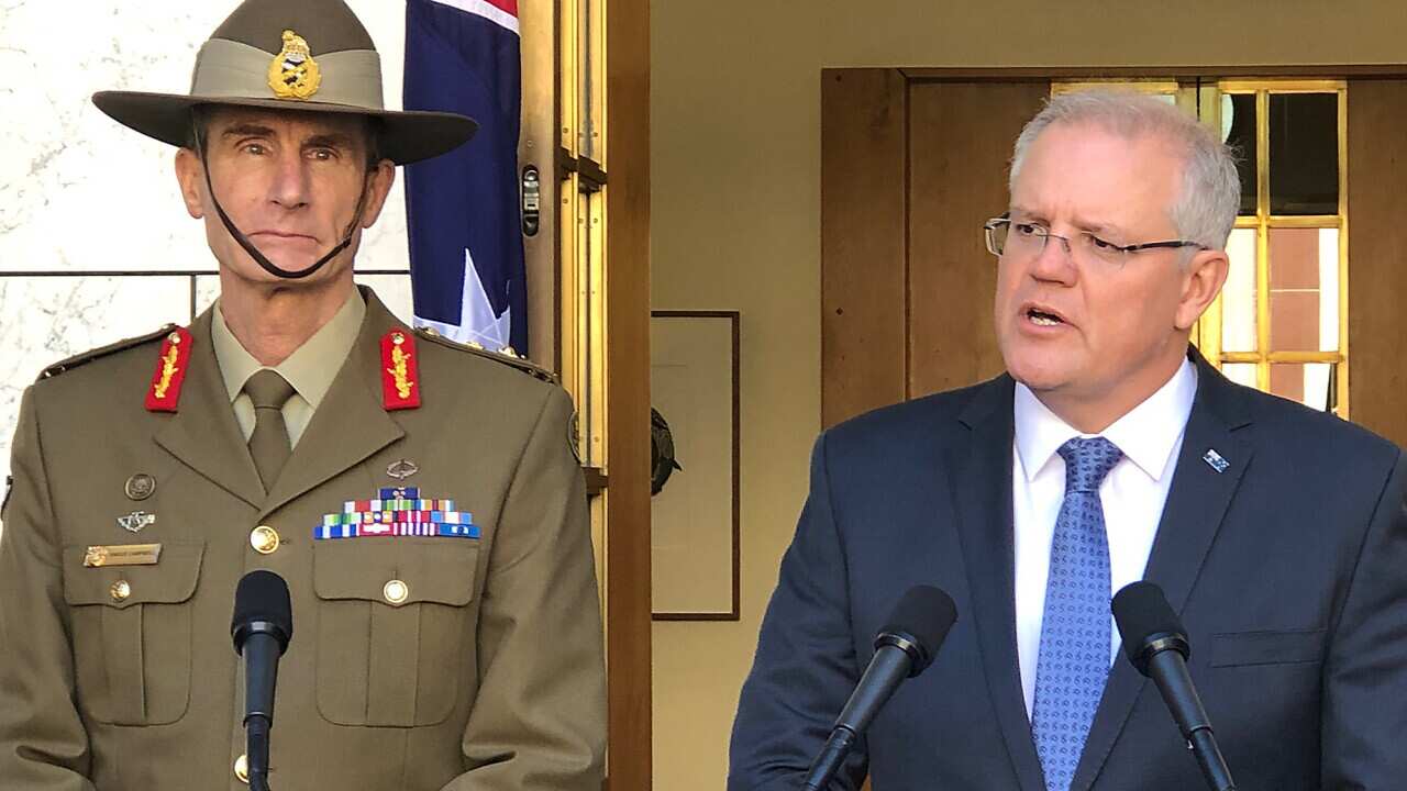 Prime Minister Scott Morrison (right) speaks to the media during a press conference at Parliament House in Canberra