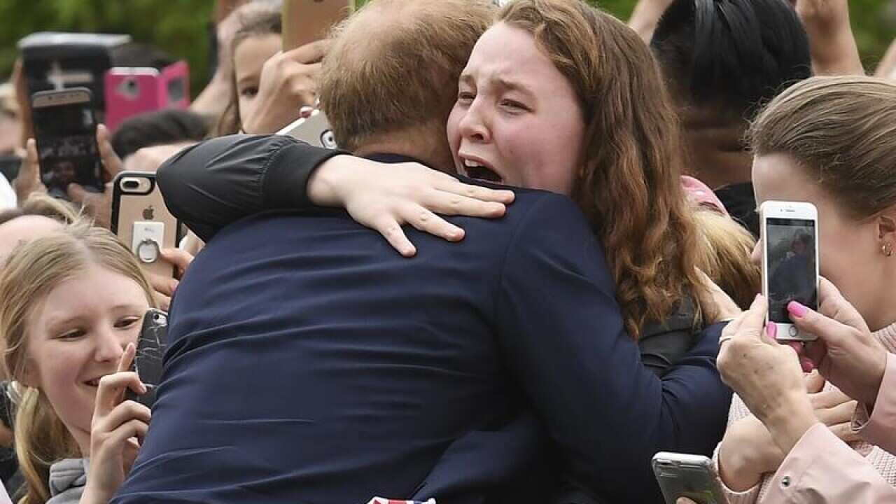 Prince Harry embraces India Brown during his Melbourne visit.