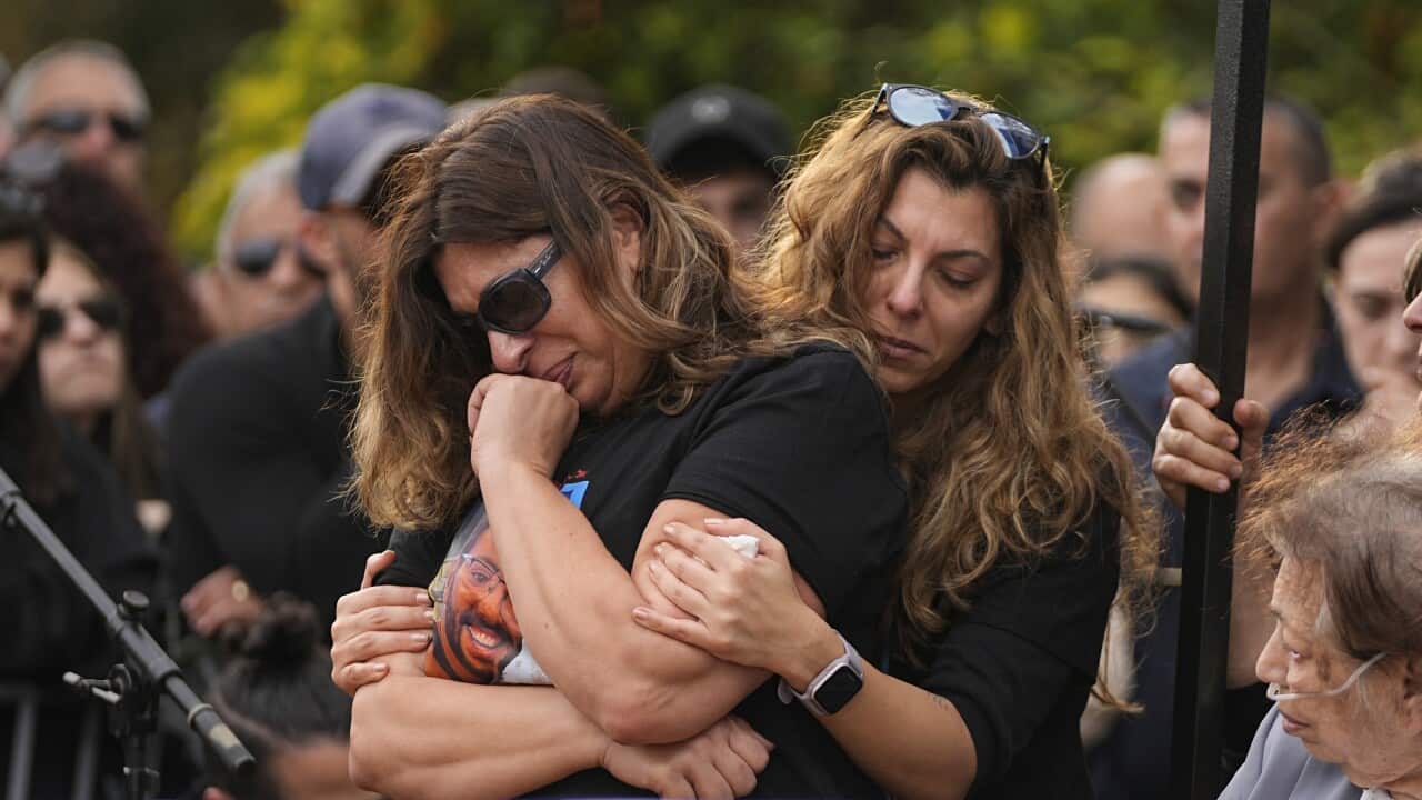 People cry at a funeral