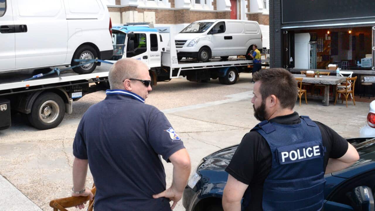 Police from various agencies at raids in South Brisbane