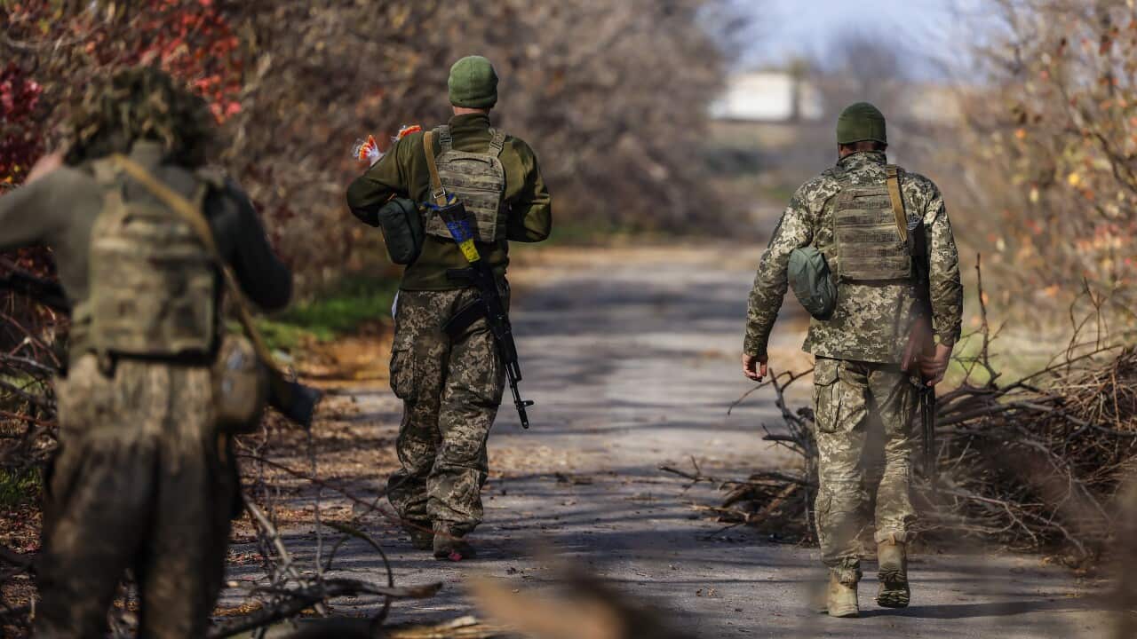 Soldiers walking on a path.