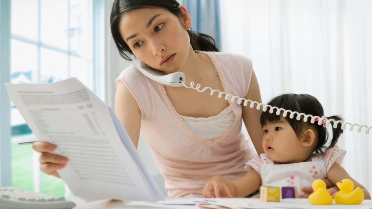 Young mother on the phone with a small child