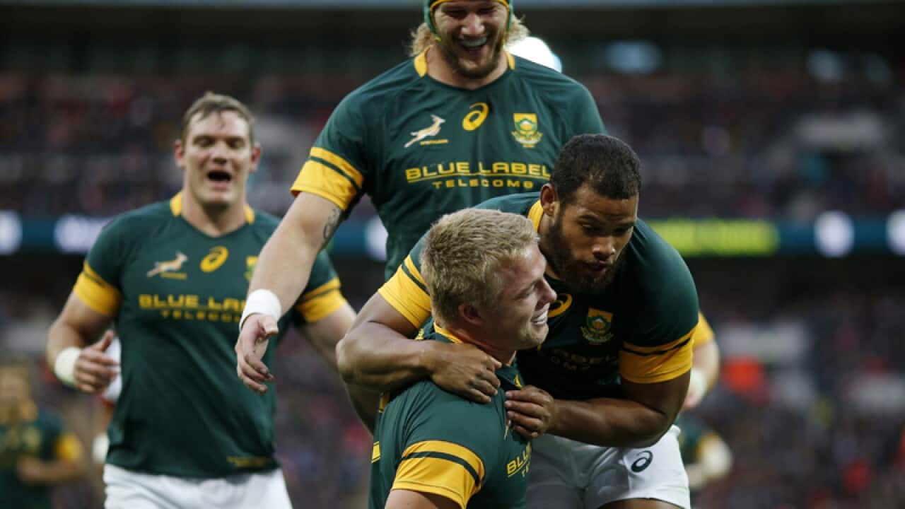 South Africa's Pieter-Steph du Toit celebrates after scoring a try