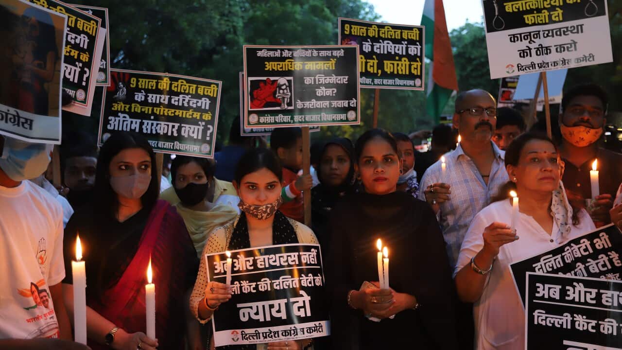 Protesters march with lit candles and placards during a silent demonstration against Primer Minister Narendra Modi and Delhi Chief Minister Arvind Kejriwal.