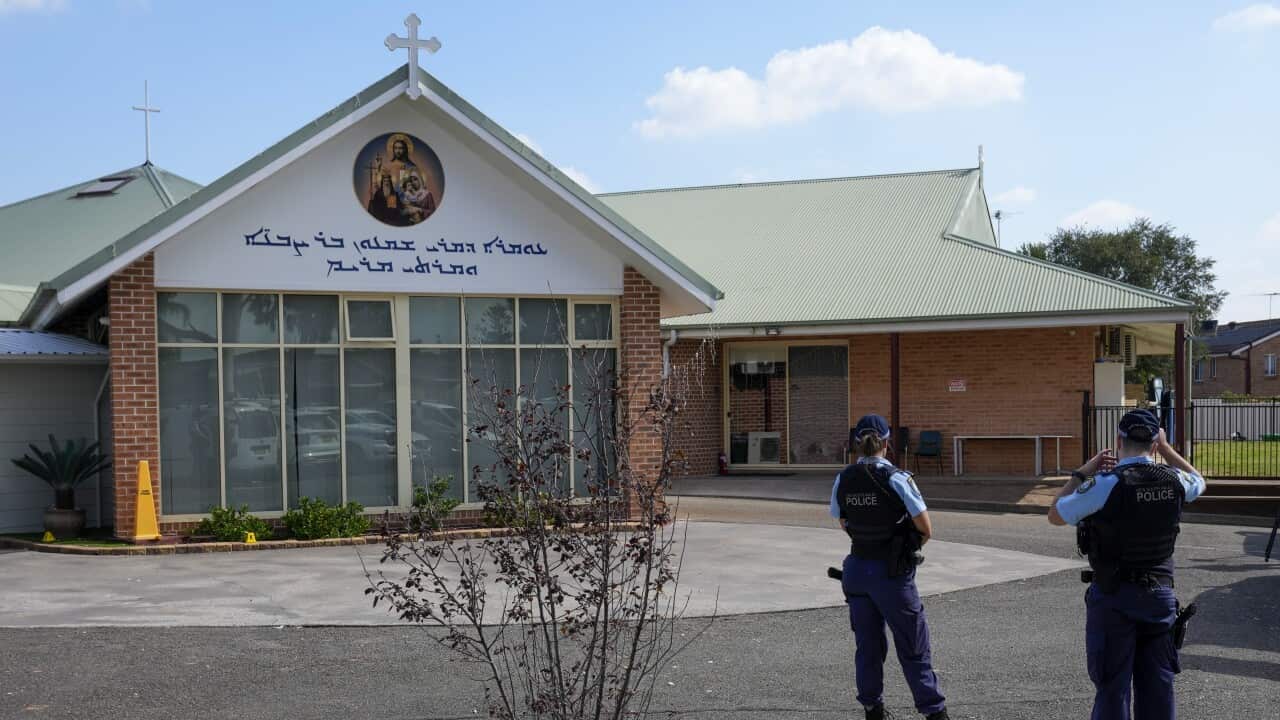 A police officer walks outside a church